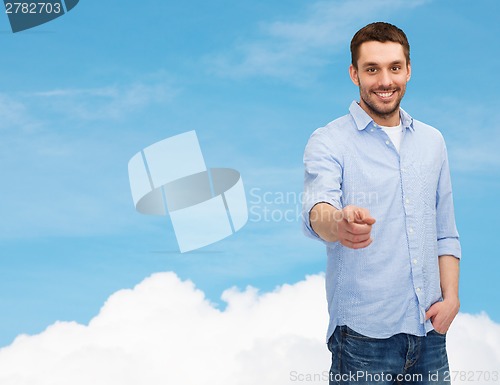 Image of smiling man pointing finger at you