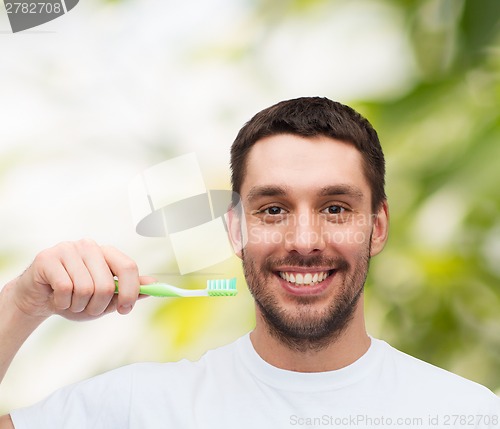 Image of smiling young man with toothbrush