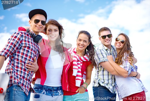 Image of group of smiling teenagers hanging out