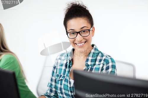 Image of african student with computer studying at school