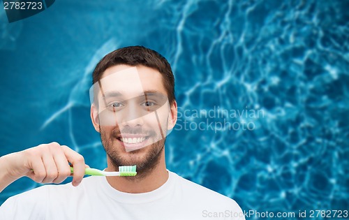 Image of smiling young man with toothbrush