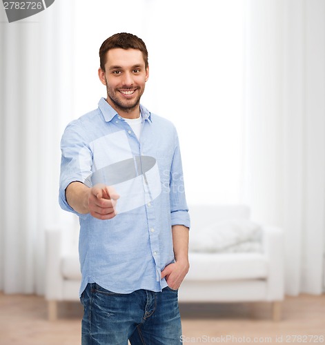 Image of smiling man pointing finger at you