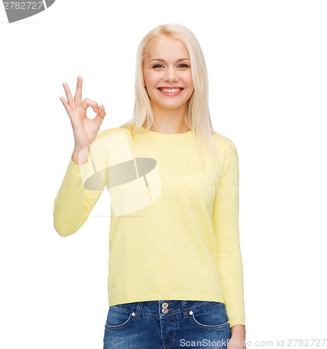 Image of young businesswoman showing ok sign