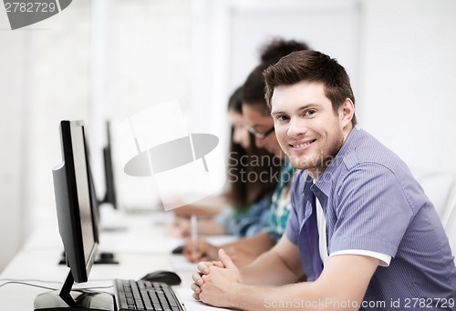 Image of student with computer studying at school