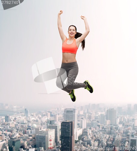 Image of sporty teenage girl jumping in sportswear