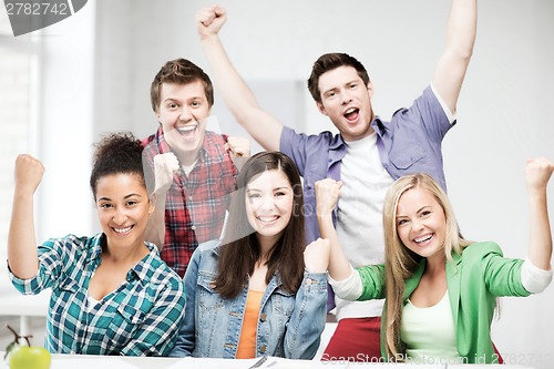 Image of students holding hands up at school