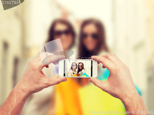 Image of close up of hands taking picture with smartphone