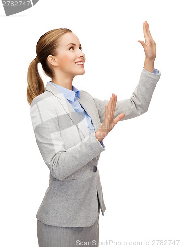 Image of smiling businesswoman pointing to something