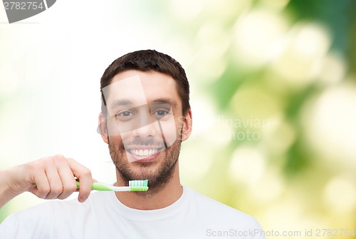 Image of smiling young man with toothbrush