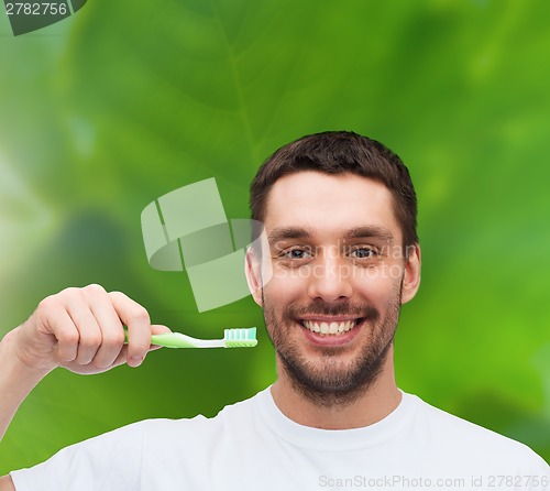 Image of smiling young man with toothbrush