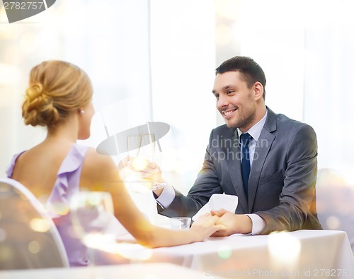 Image of couple with glasses of champagne at restaurant