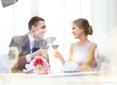 Image of young couple with glasses of wine at restaurant