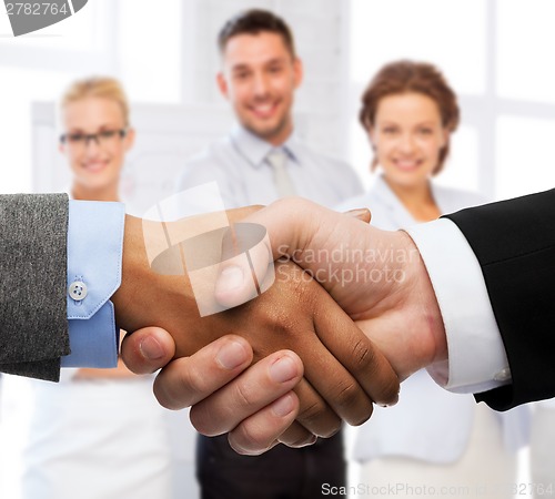 Image of businessman and businesswoman shaking hands