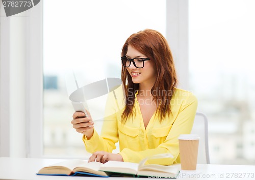 Image of smiling student girl with smartphone at school