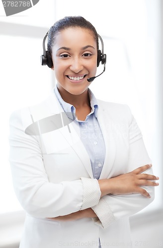 Image of african helpline operator with headphones