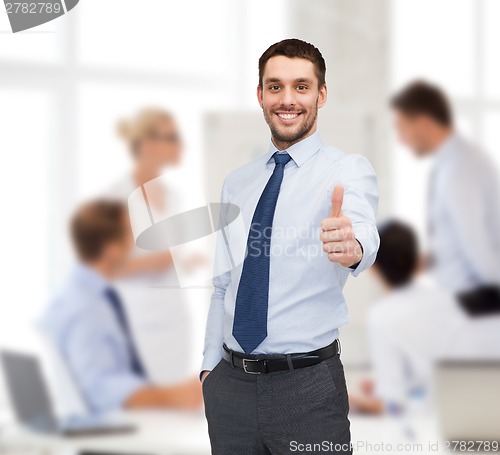 Image of handsome businessman showing thumbs up