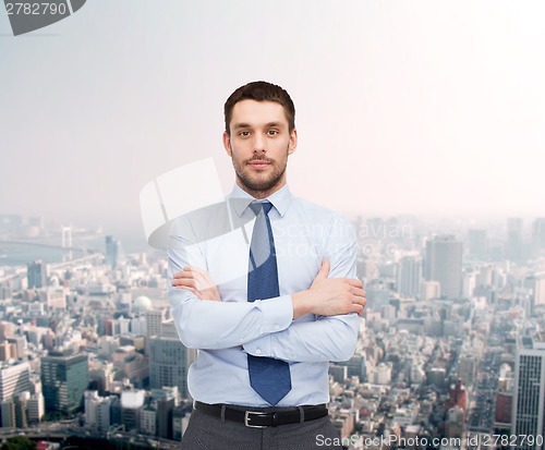 Image of handsome businessman with crossed arms