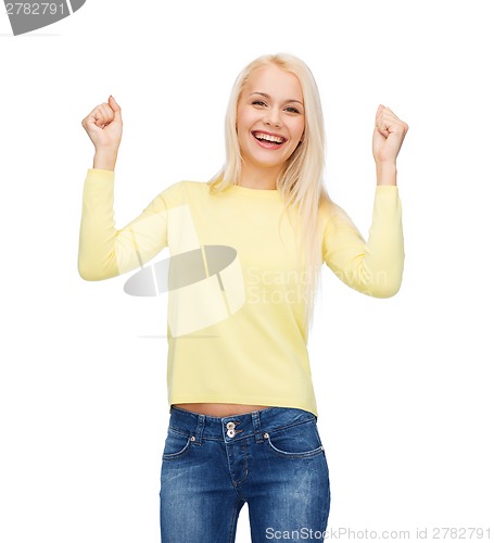 Image of laughing young woman with hands up