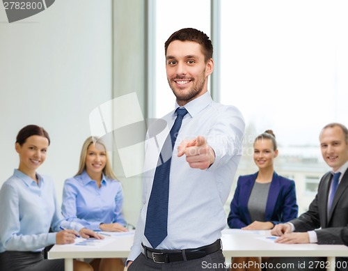 Image of handsome businessman pointing finger at you