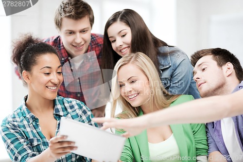 Image of students looking at tablet pc at school