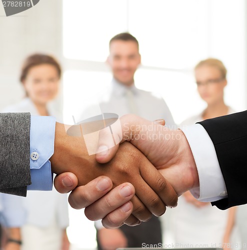 Image of businessman and businesswoman shaking hands