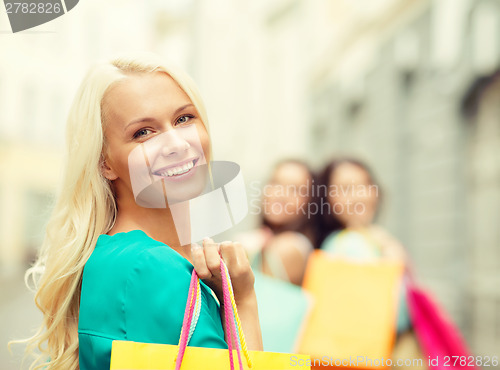 Image of beautiful woman with shopping bags in the ctiy