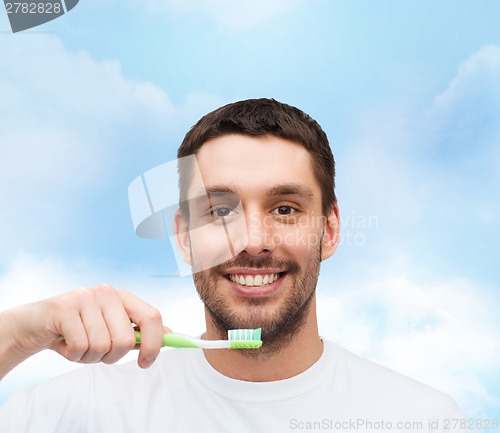 Image of smiling young man with toothbrush