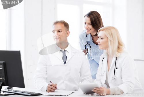 Image of doctors looking at computer on meeting