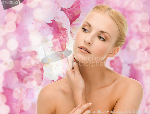 Image of beautiful woman touching her face skin