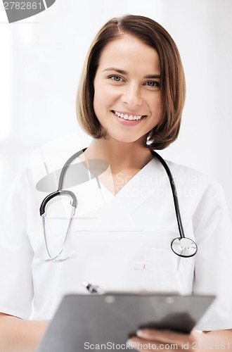Image of doctor with stethoscope writing prescription
