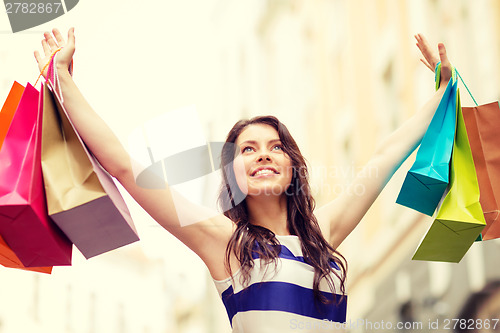 Image of beautiful woman with shopping bags in the ctiy