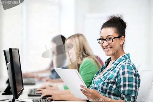 Image of african student with computer studying at school