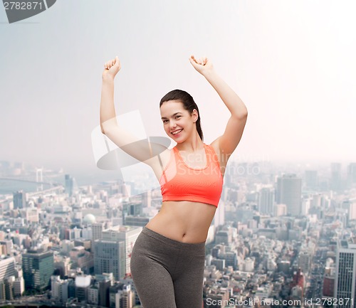 Image of smiling teenage girl in sportswear dancing