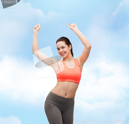 Image of smiling teenage girl in sportswear dancing