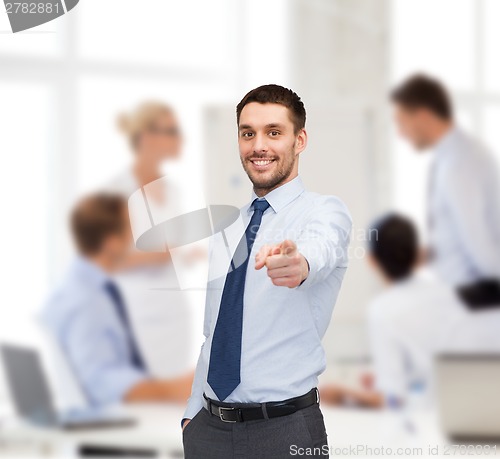 Image of handsome businessman pointing finger at you