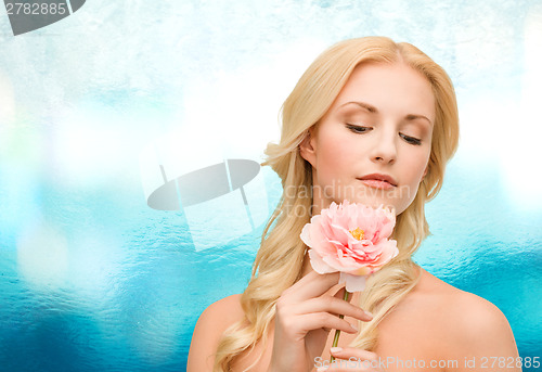 Image of lovely woman with peony flower