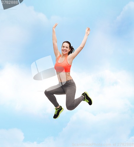 Image of sporty teenage girl jumping in sportswear