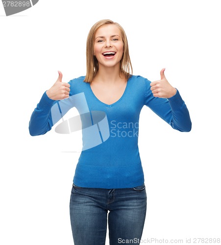 Image of smiling girl in casual clothes showing thumbs up