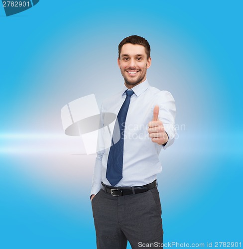Image of handsome businessman showing thumbs up