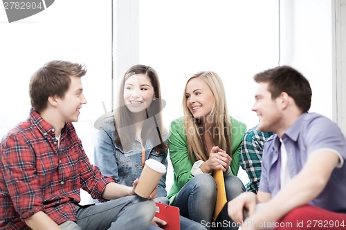 Image of students communicating and laughing at school