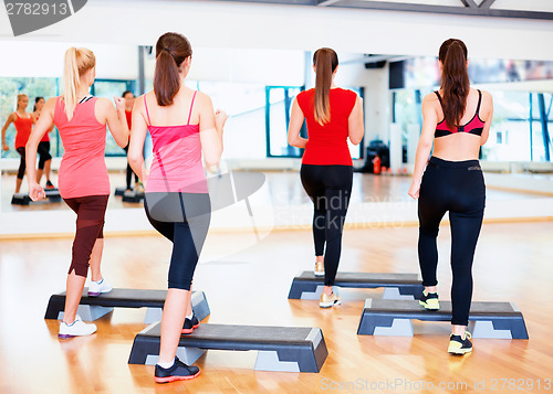 Image of group of smiling people doing aerobics