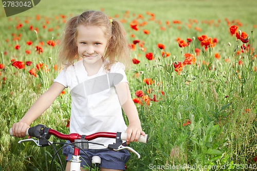 Image of Happy smiling little girl with bicycle