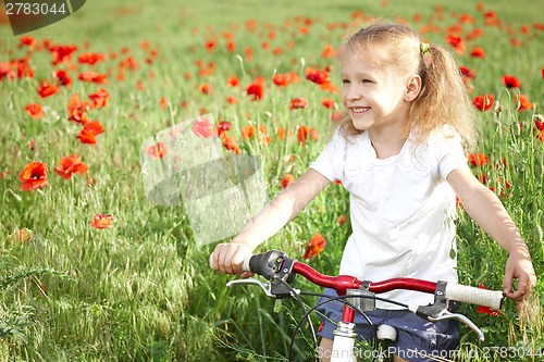 Image of Happy smiling little girl with bicycle