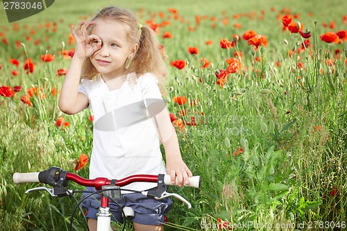 Image of Happy smiling little girl with bicycle