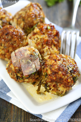 Image of Plate with meatballs and sauce.