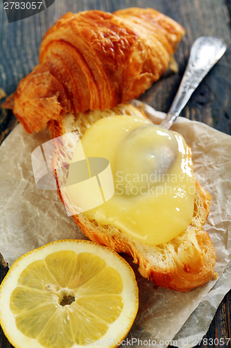 Image of Croissant with cream and lemon.