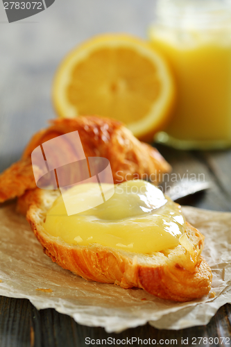 Image of Fresh croissant with lemon curd.