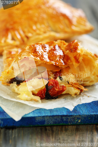 Image of Patties with cheese, sun-dried tomatoes and basil.