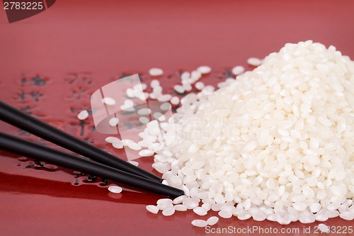 Image of Rice and chopsticks on a plate