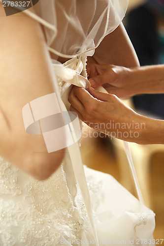 Image of Bride when tightening the dress